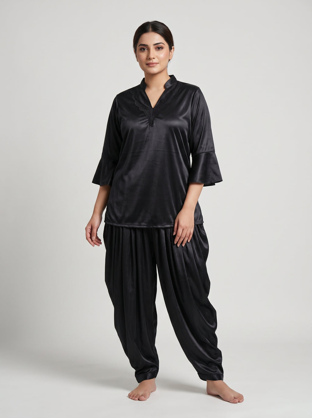 Indulge in effortless elegance with this luxurious black satin night suit, featuring a beautifully detailed lace-trimmed neckline and stylish flared sleeves.