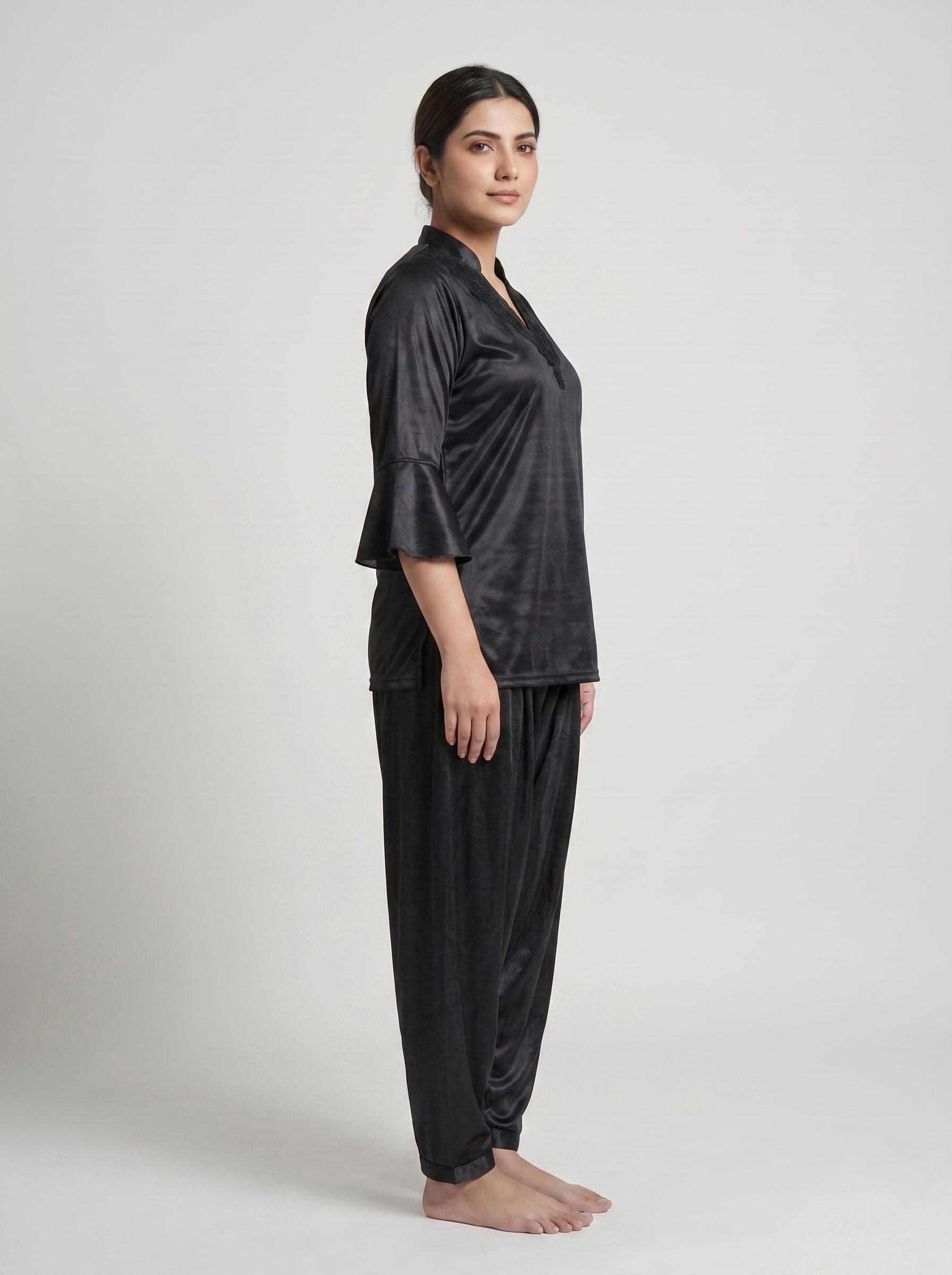 Indulge in effortless elegance with this luxurious black satin night suit, featuring a beautifully detailed lace-trimmed neckline and stylish flared sleeves.