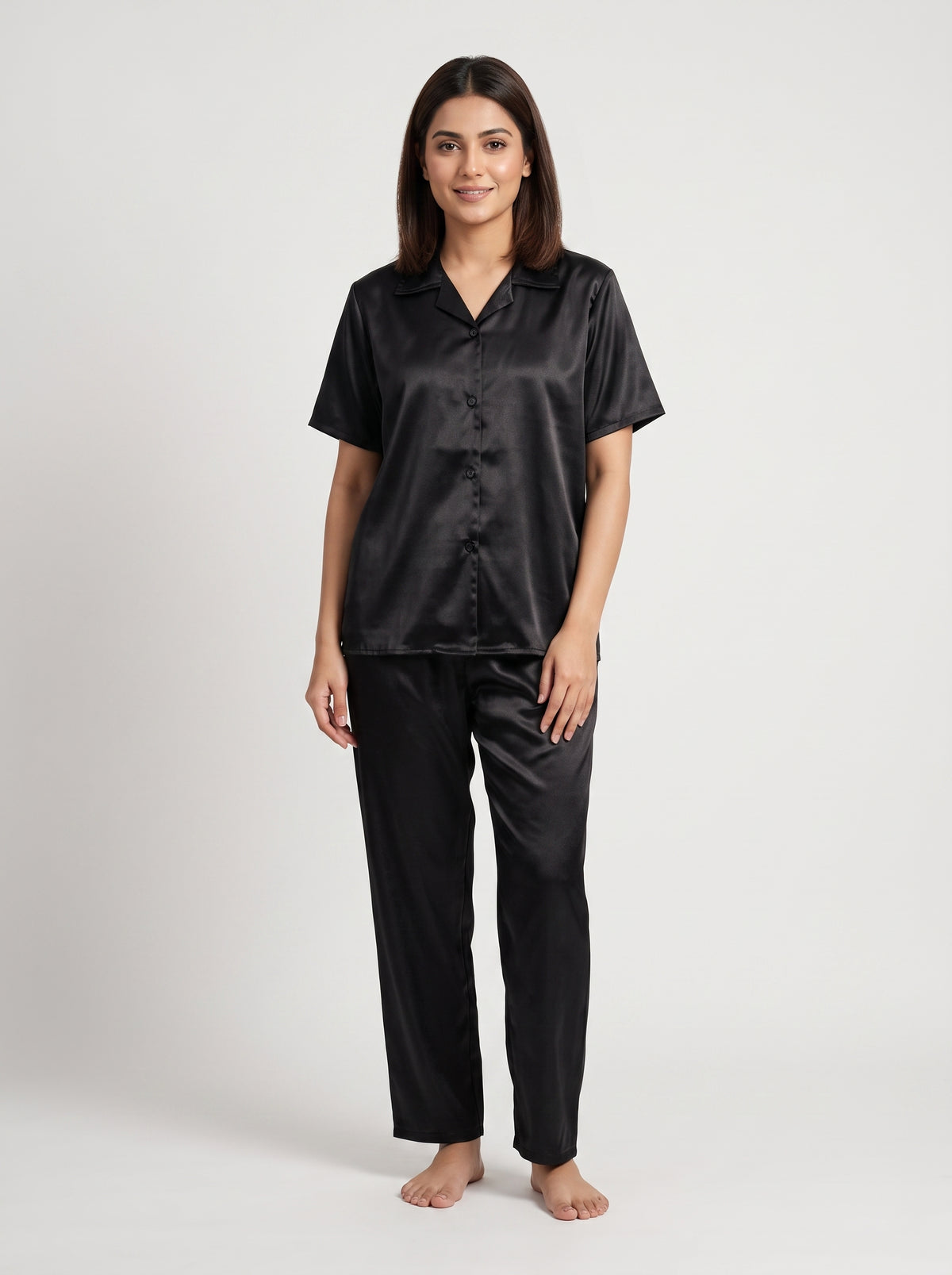 Enjoy timeless elegance and everyday comfort with this classic black satin pajama set. Designed with a relaxed button-down shirt and matching trousers,