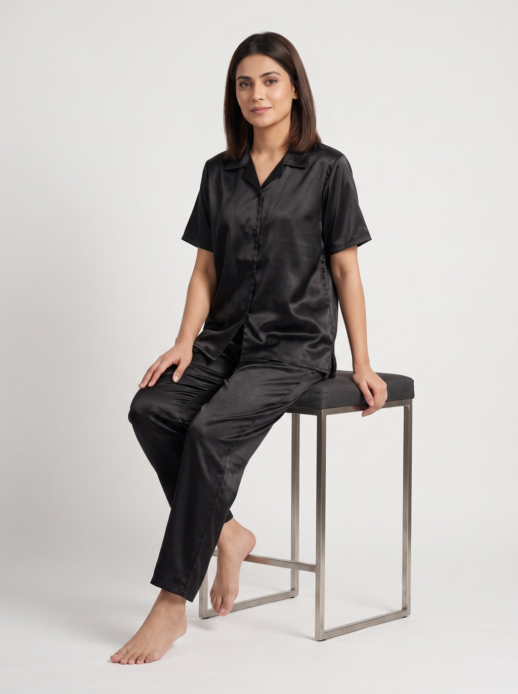 Enjoy timeless elegance and everyday comfort with this classic black satin pajama set. Designed with a relaxed button-down shirt and matching trousers,