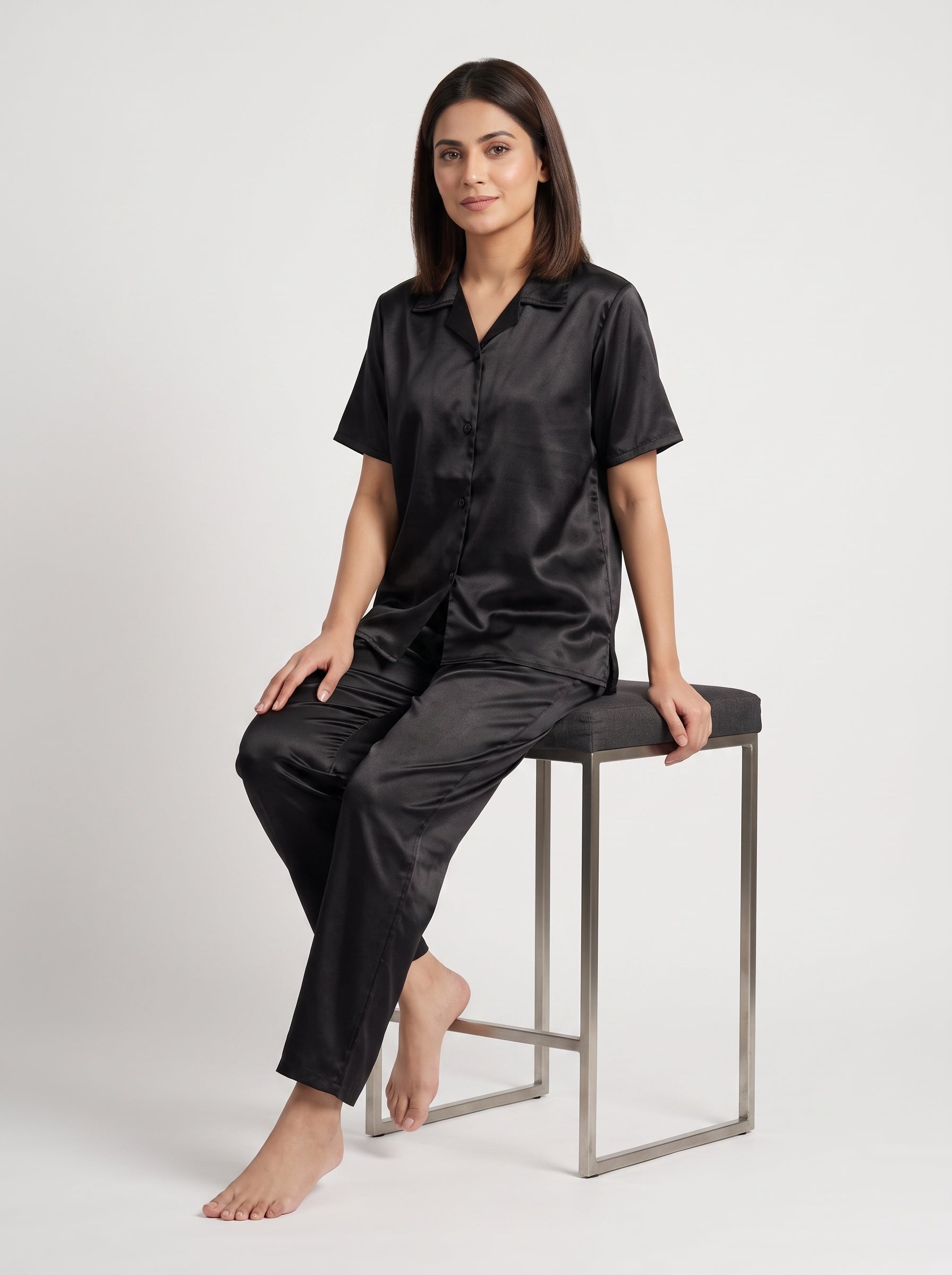 Enjoy timeless elegance and everyday comfort with this classic black satin pajama set. Designed with a relaxed button-down shirt and matching trousers,
