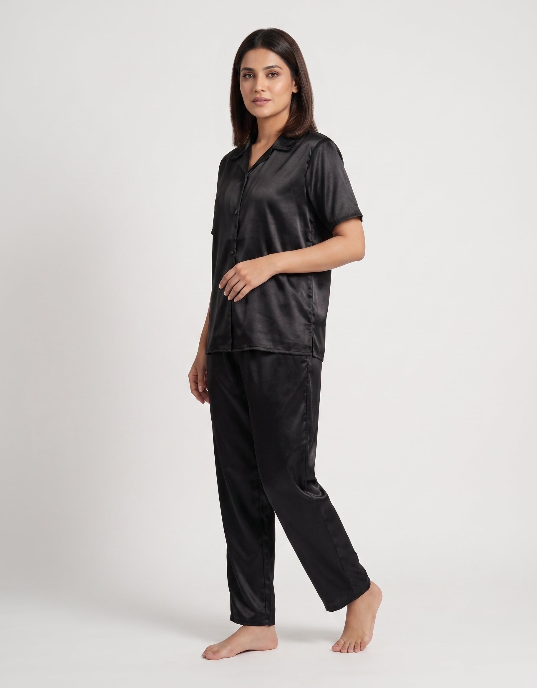 Enjoy timeless elegance and everyday comfort with this classic black satin pajama set. Designed with a relaxed button-down shirt and matching trousers,