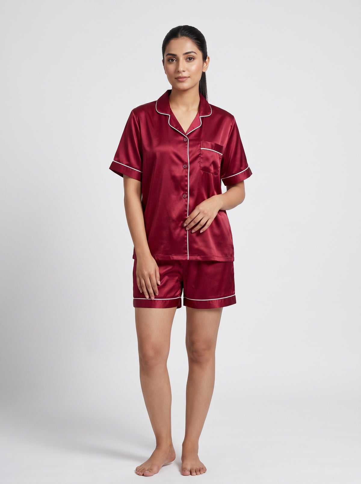 Relax in effortless comfort with this elegant satin pajama set, designed with a classic button-down top and matching shorts