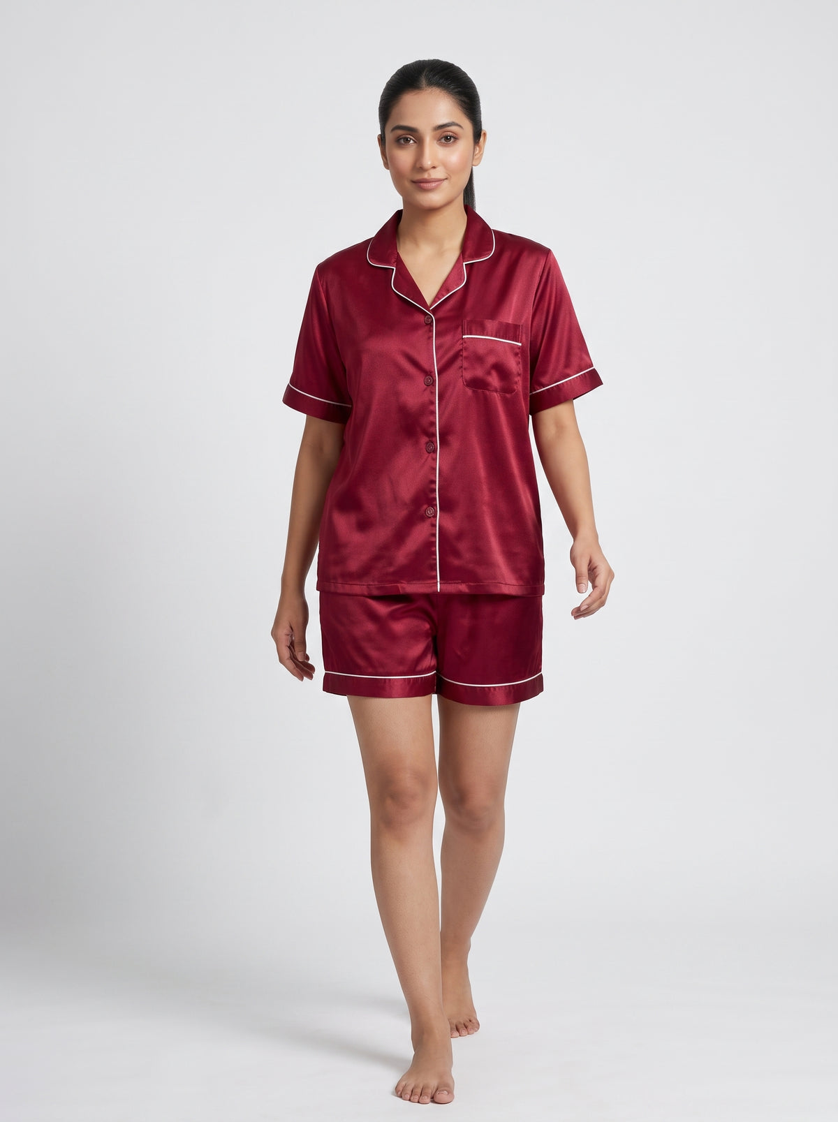 Relax in effortless comfort with this elegant satin pajama set, designed with a classic button-down top and matching shorts
